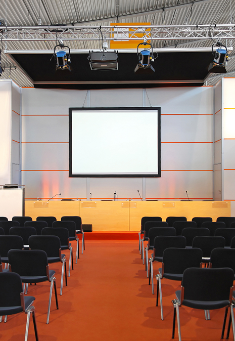 Genesis Coworking Space — conference room with projector screen and seating